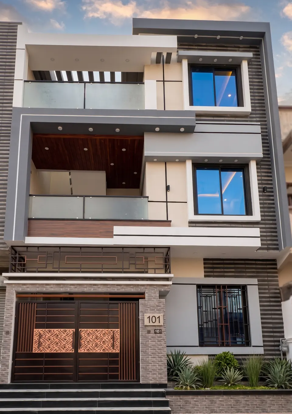 Delivered home in Karachi. Front elevation with stone cladding and tower detailing.